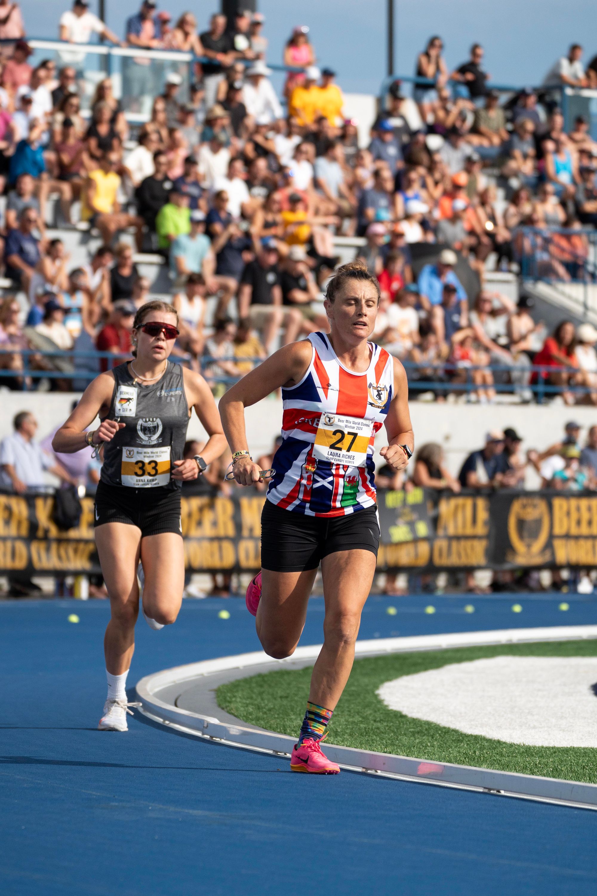 Laura Riches (England) leads Anna Kamp (Germany) in the middle of the 2024 Beer Mile World Classic