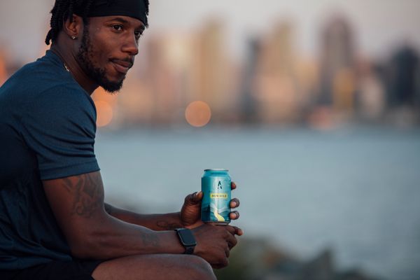 Carlin Isles (U.S. National Rugby Team member) sips Athletic Brewing's Run Wild Non-Alcoholic Beer